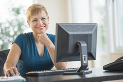 Image of Lady Smiling from desk.